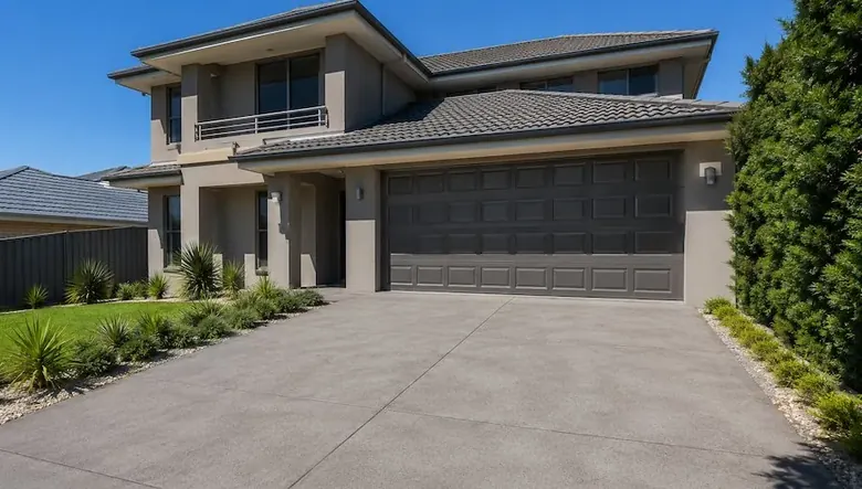 Plain concrete driveway in Perth WA with modern two-storey family home