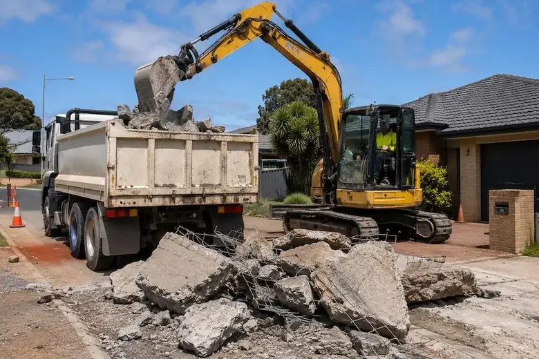 Broken driveway concrete being loaded into a truck for concrete disposal in Perth