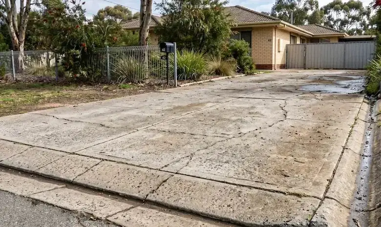Concrete driveway with surface cracking and drainage issues in Perth WA