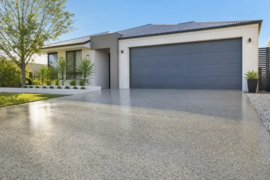 Honed concrete driveway in front of a Perth home